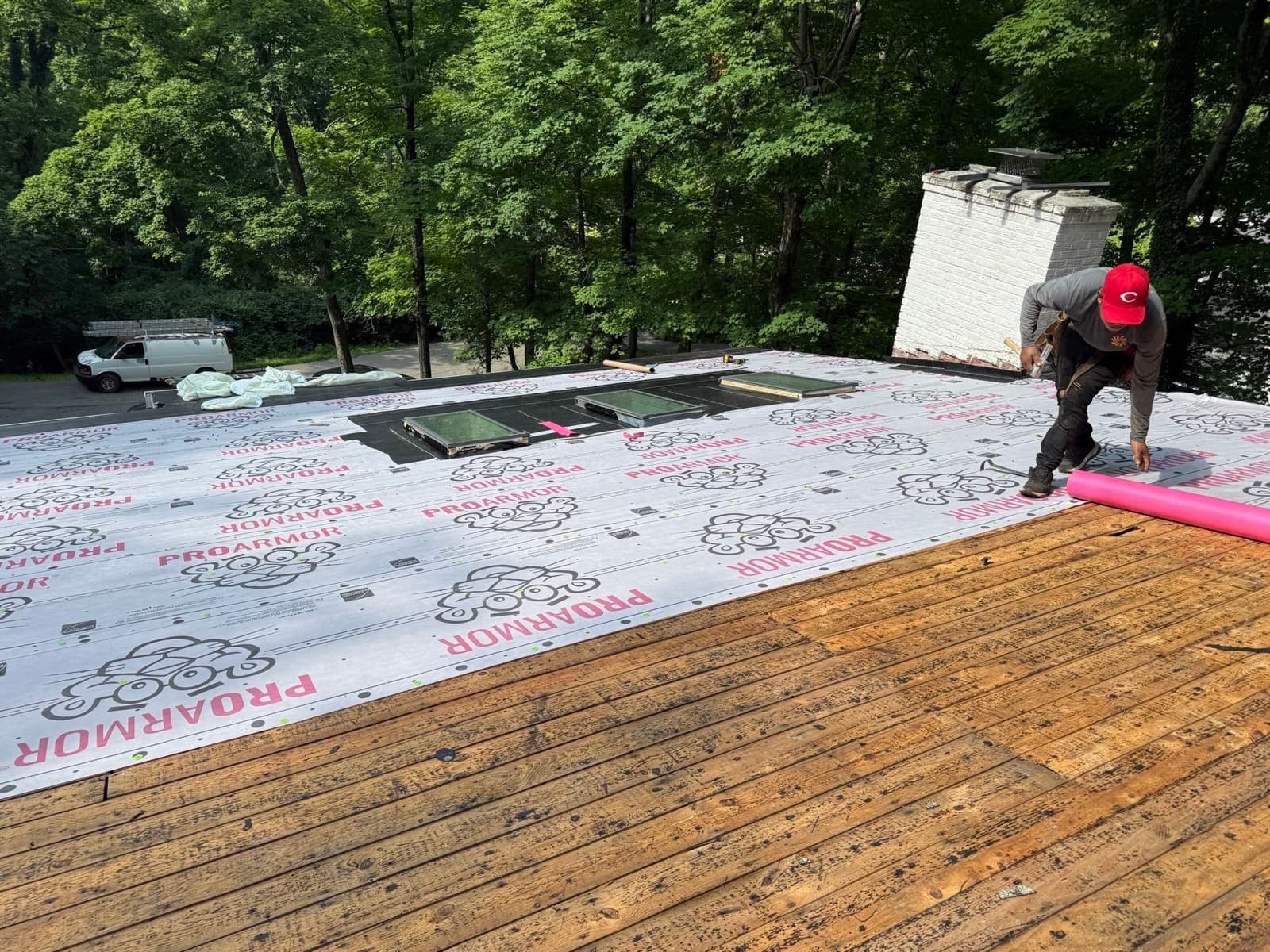 Integrity Premier Exteriors crew installing synthetic underlayment on a Cincinnati roof
